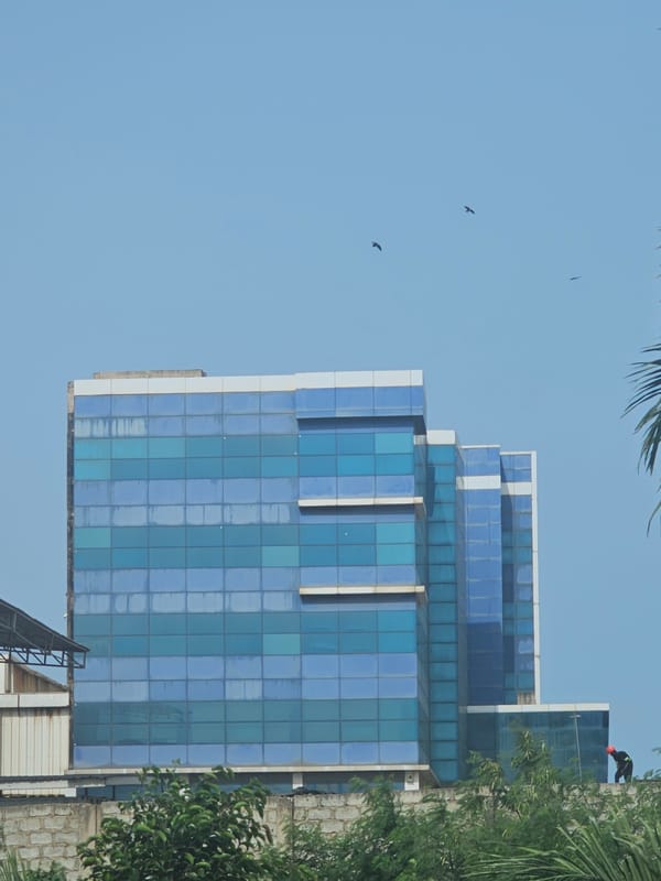 Motorcycles parked near modern skyscraper in Accra