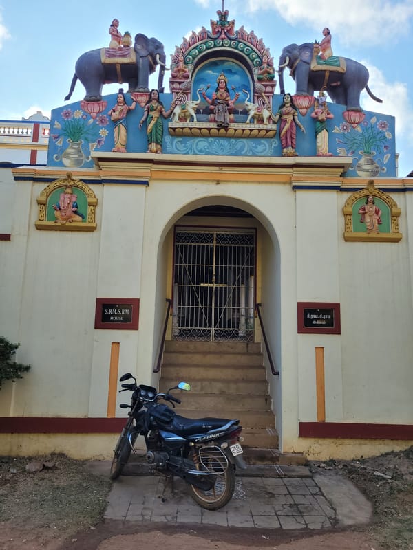 Ornate building with colorful sculptures documented under clear sky