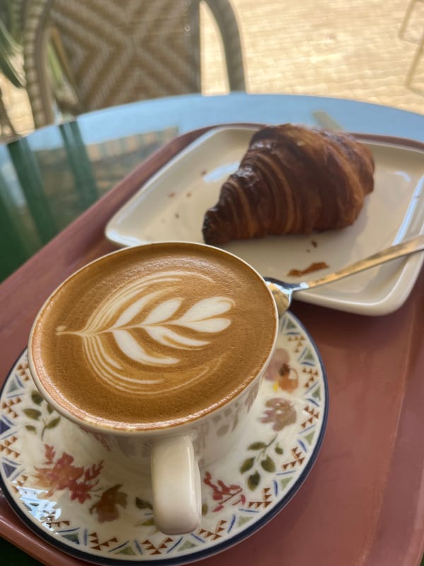 Morning beachgoers gather along Alanya coastline, boat spotted offshore