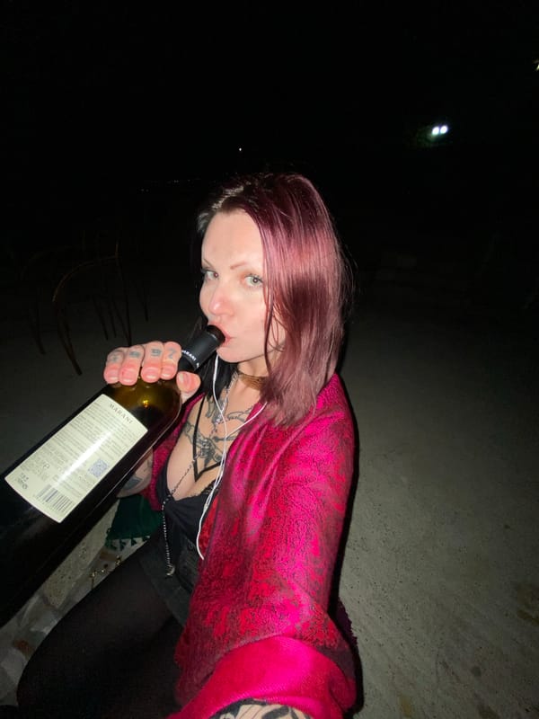 Woman drinks wine, smokes outdoors in Kunje, Montenegro