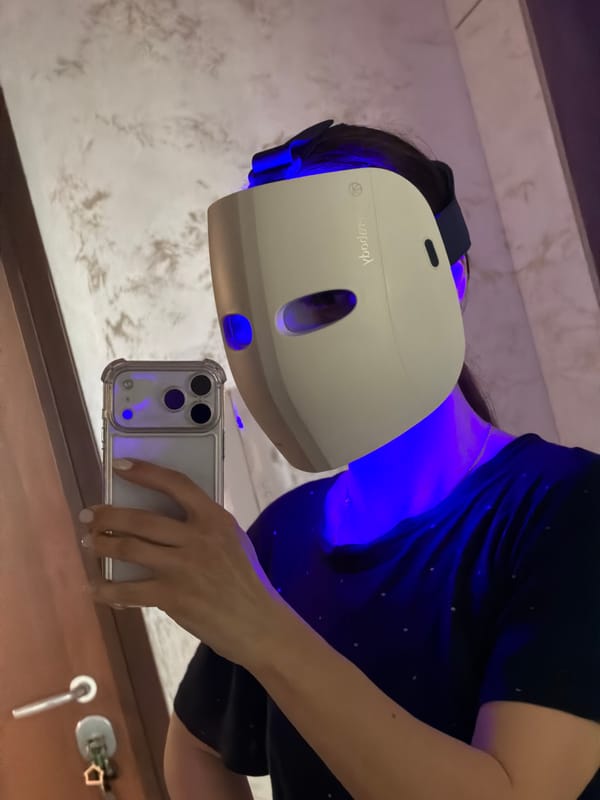 Woman takes selfie wearing blue light face mask in Varna