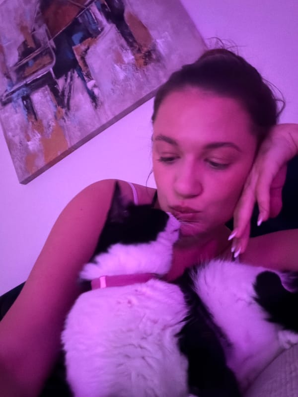 Woman shares quiet moments with black and white cat in Belgrade