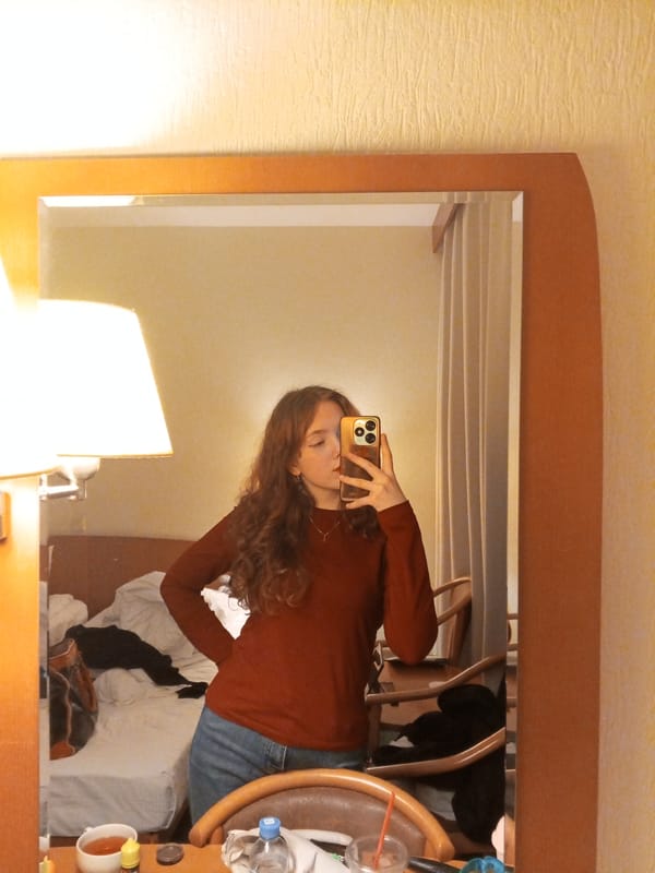 Woman takes mirror selfies in Saint Petersburg hotel room