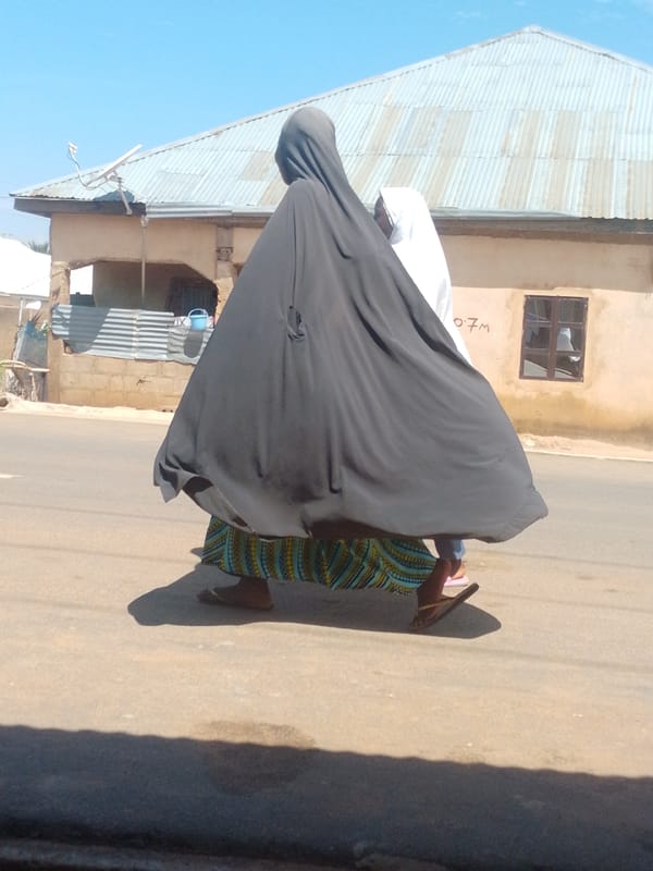 Morning foot traffic along a dusty small-town road