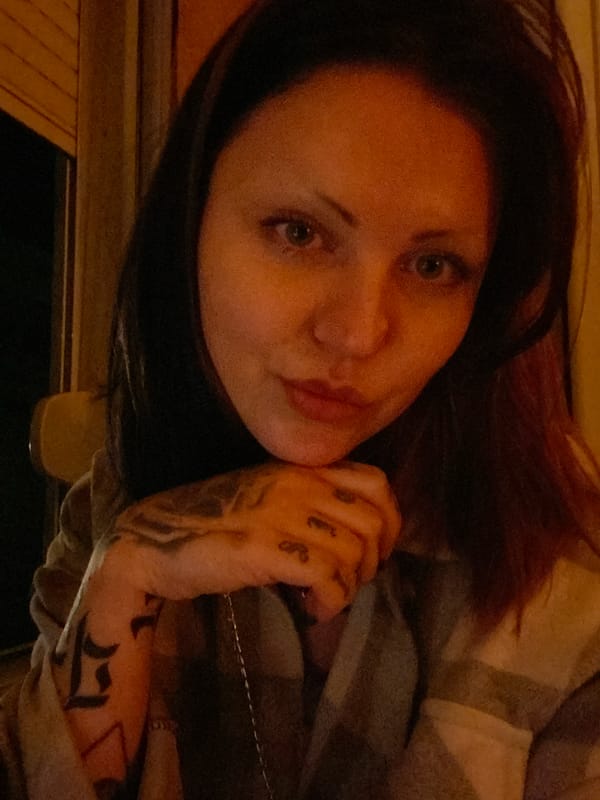 Woman with tattoos photographed using tablet in Montenegro village