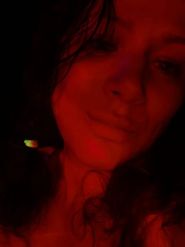 Colored light portrait session captured in dimly lit environment