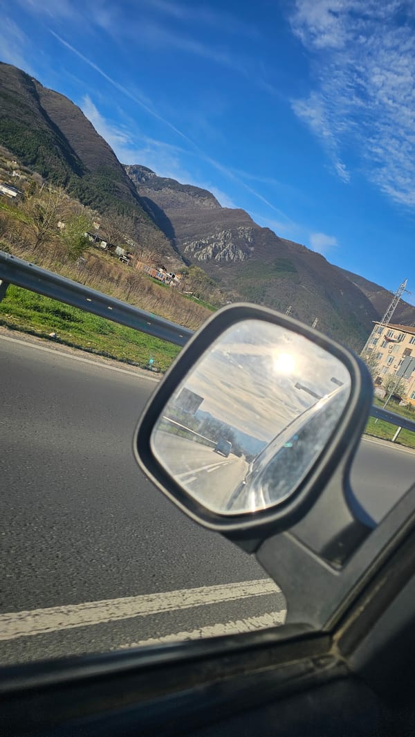 Highway travel documented through side mirror in Sopot, Bulgaria