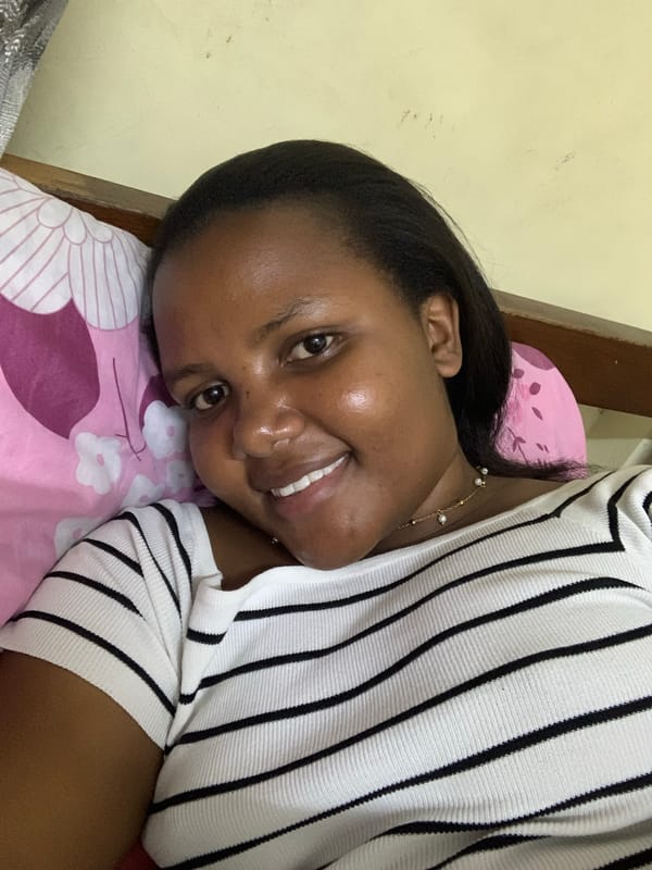 Woman rests on floral pillow in Dar es Salaam bedroom