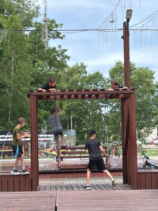 Kids at a splash pad and playground in Birobidzhan on a summer day