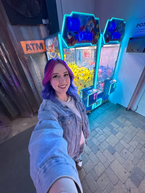 Woman takes selfie at Pikachu claw machine arcade Budapest