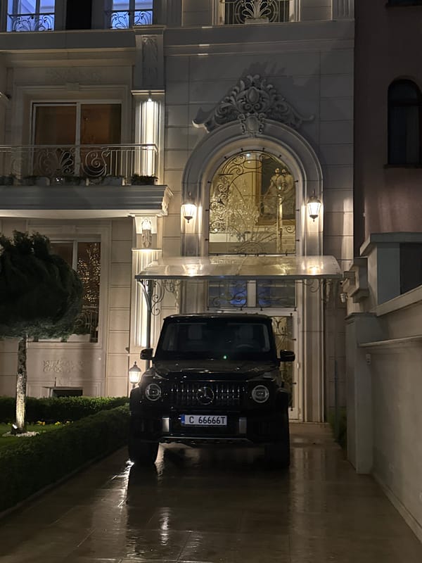 Black SUV parked outside ornate building in Sofia