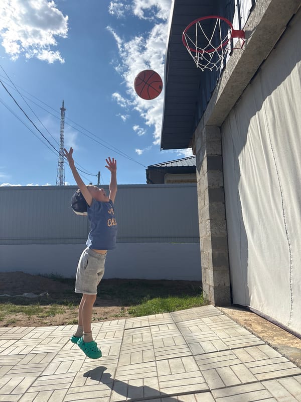 Child makes basketball shot in Chaikovsky, Russia