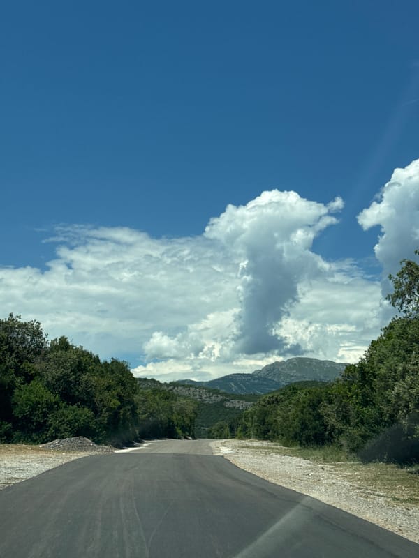 Mountain road and rocky shoreline in coastal Montenegro
