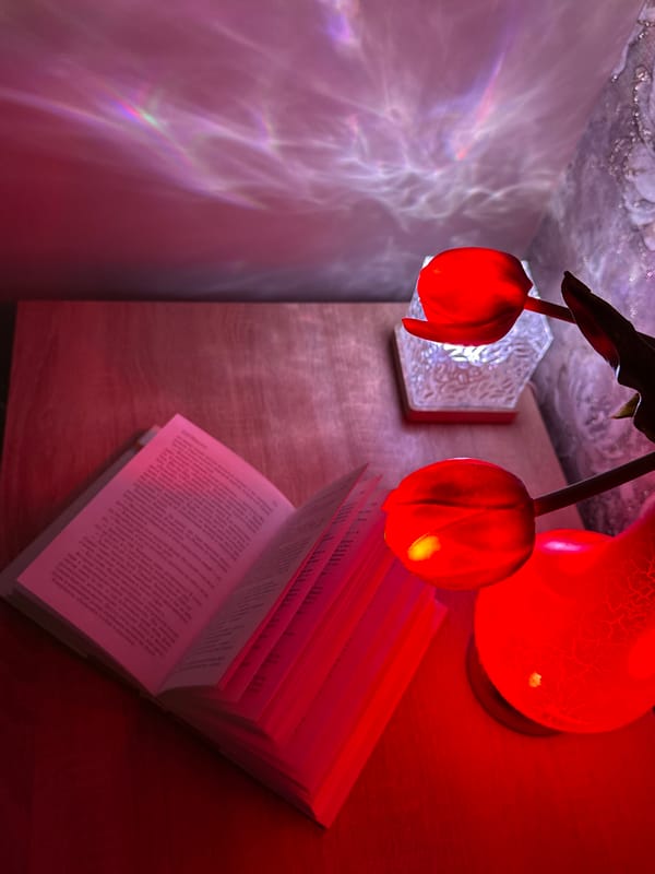Open book with Cyrillic text photographed under red lighting