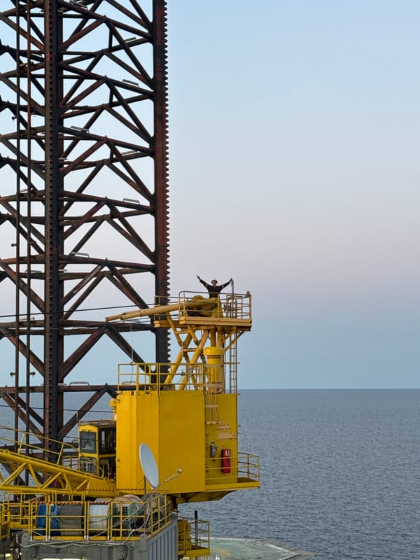 Workers observed on Italian offshore oil platform during sunset