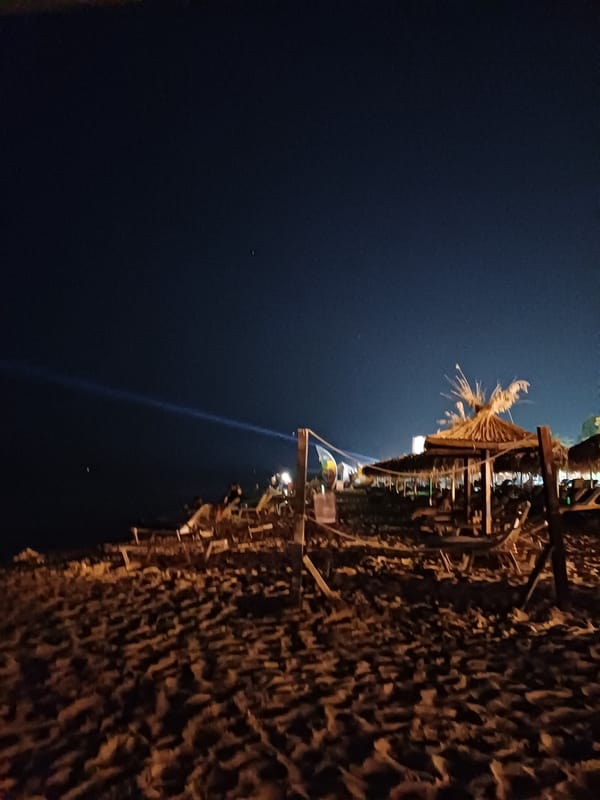 Summer night on Varna's beach: lanterns, loungers, and a crowd