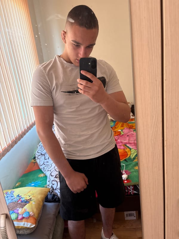 Young man takes mirror selfie in Asenovgrad bedroom
