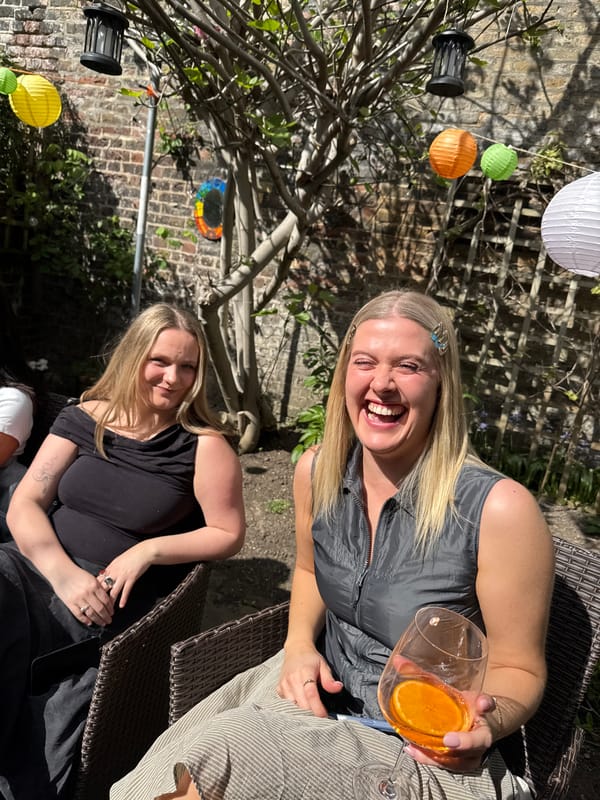 Two women enjoy sunny afternoon gathering in London garden