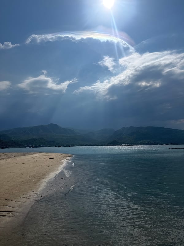 Sun halos over a tranquil Vietnamese beach morning
