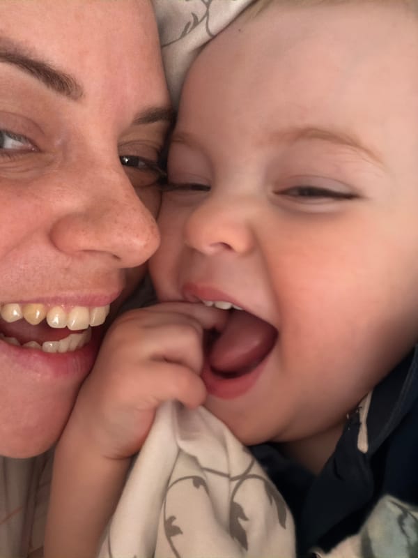 Baby plays with toys alongside chihuahua in Votkinsk bedroom