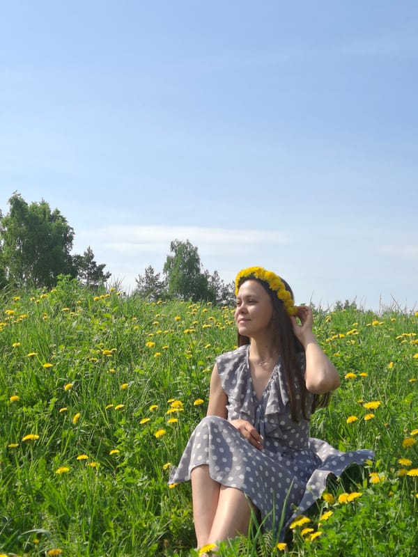 Woman poses with dandelions in Russian field photoshoot