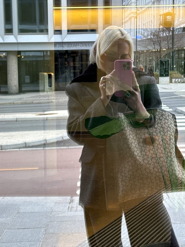 Blonde woman films fashion content with Celine bag in Oslo