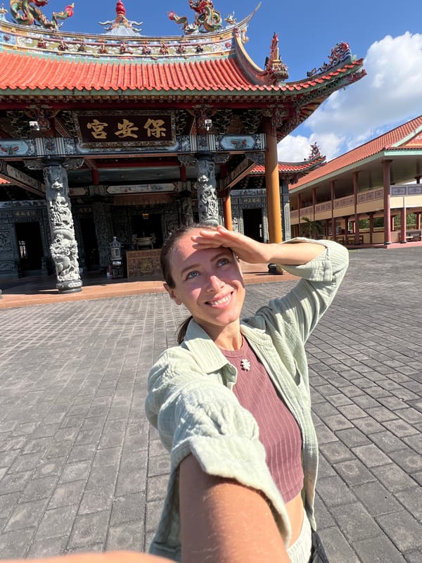 Tourist visits ornate Buddhist temple complex in Denpasar, Indonesia
