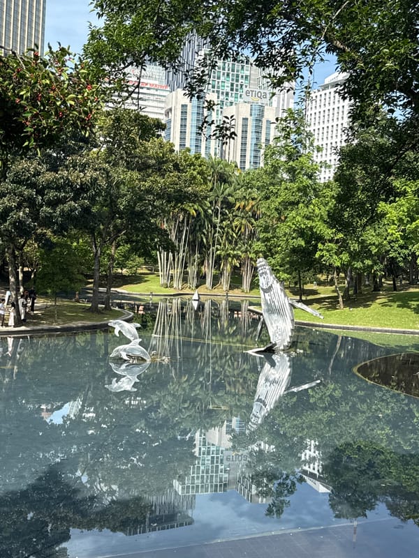 Late-night strollers enjoy Kuala Lumpur parks near Petronas Towers