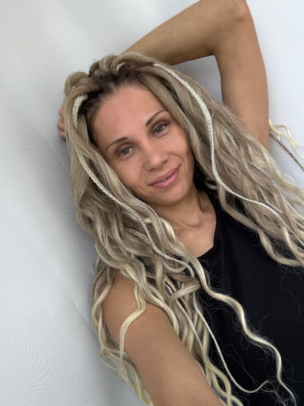 Woman with braided hair observed on white surface in Rusanovo
