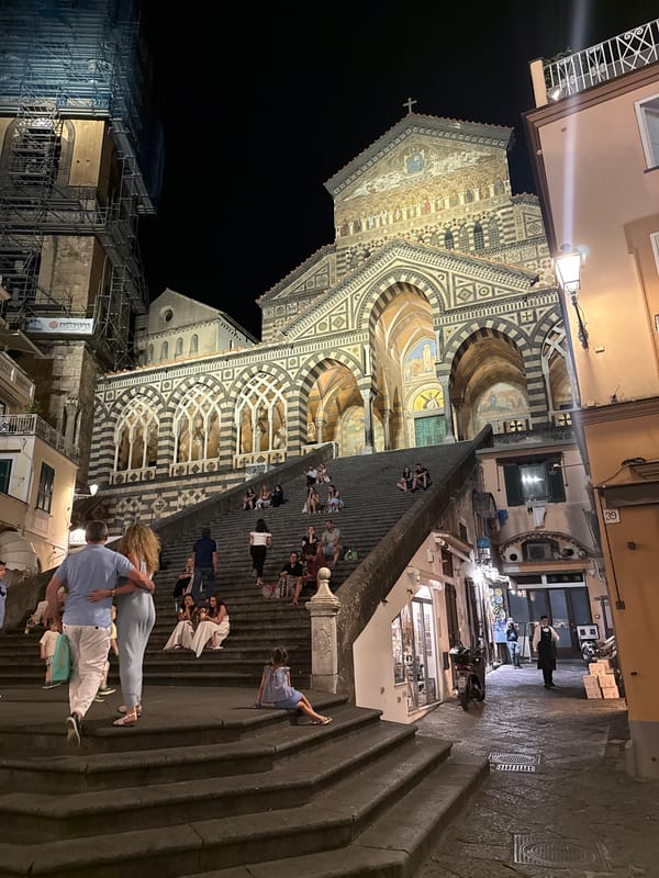 Ornate cathedral with striped arches documented at night in Pogerola