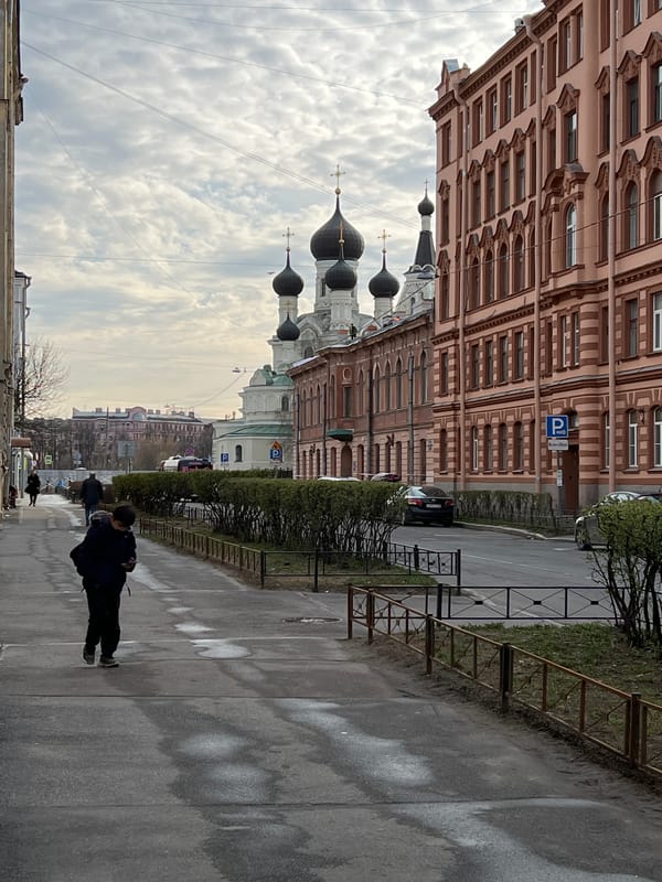 Everyday street life documented near Orthodox church in Saint Petersburg