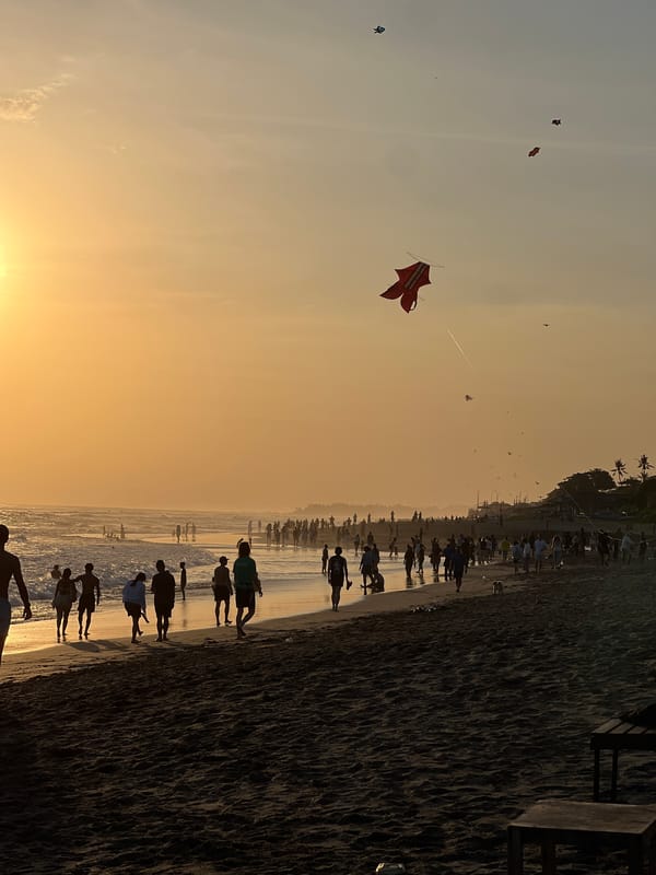 Kuta Beach at golden hour, busy and laid-back