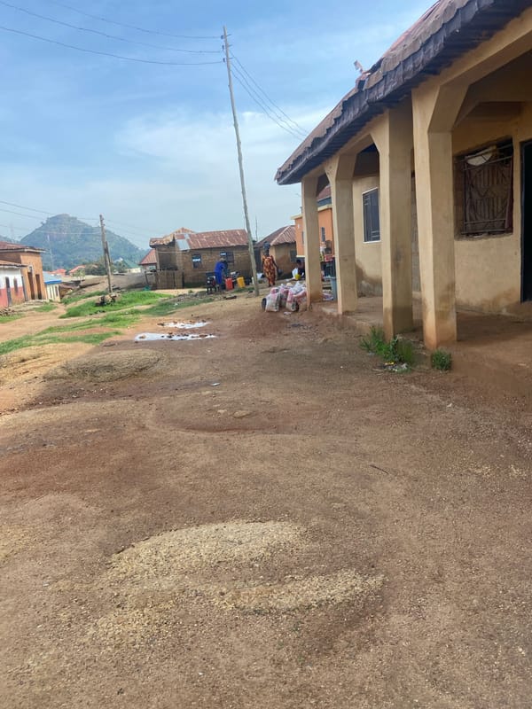 Street-level look at a Jos neighborhood's roads and buildings