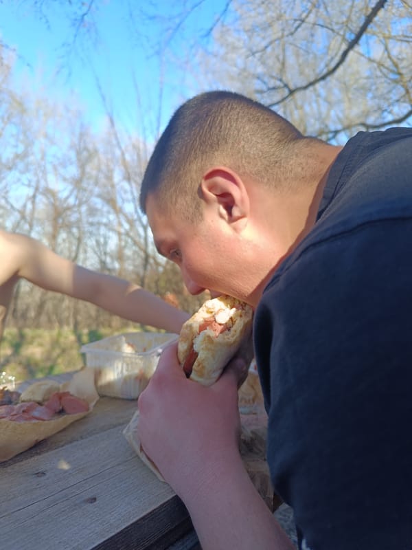 Man enjoys outdoor lunch on sunny afternoon