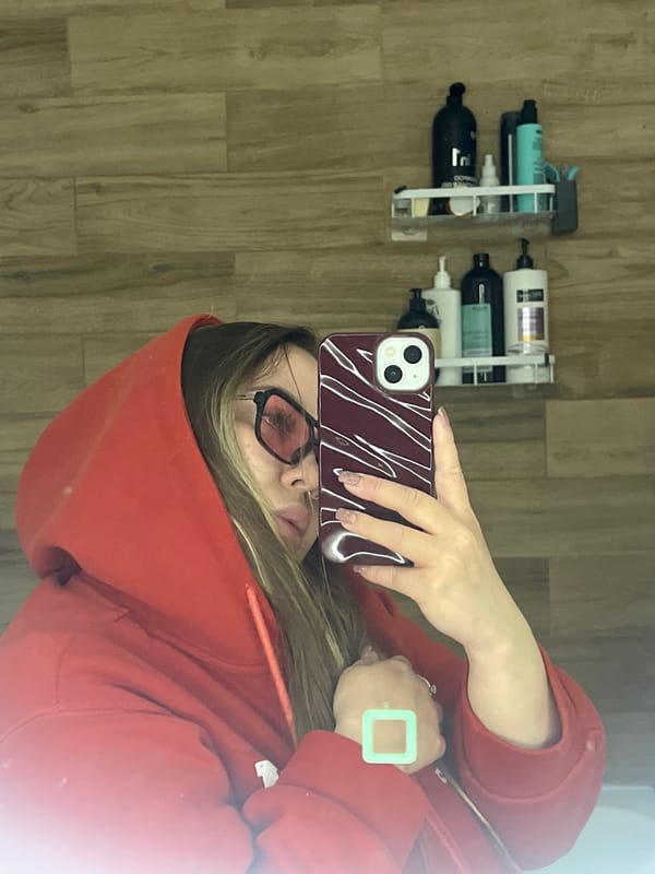 Person takes mirror selfies in red hoodie in Krasnodar