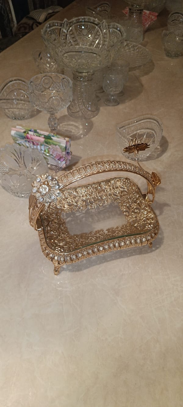 Ornate gold trays and crystal pieces in a formal interior setting