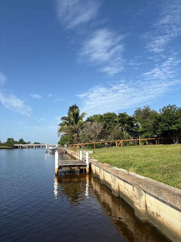 Sunny afternoon along a calm residential canal waterfront