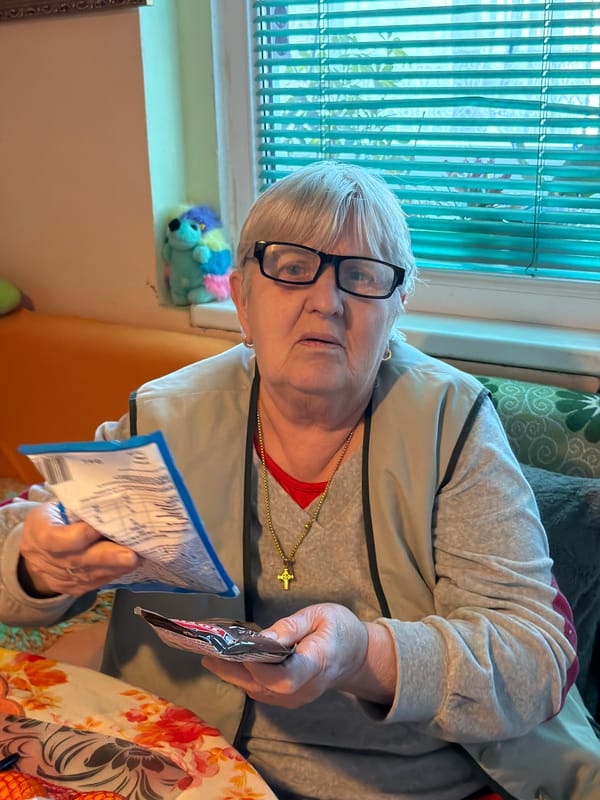 Elderly woman in red shirt observed indoors in Varna