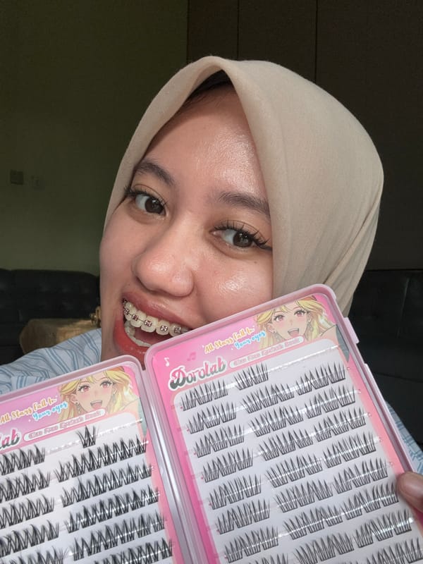 Woman displays false eyelash products in Gadingrejo, Indonesia