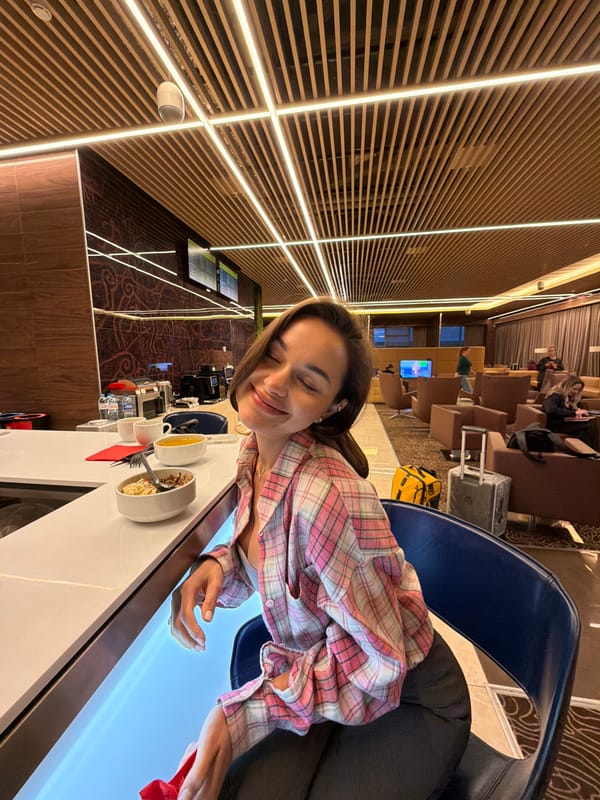 Woman in plaid shirt observed dining at airport lounge