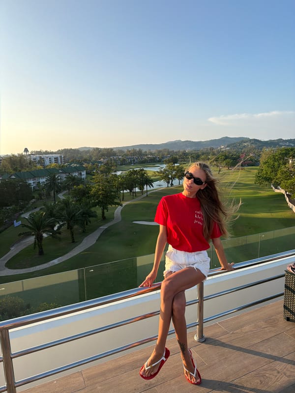 Woman poses on balcony overlooking Phuket golf course