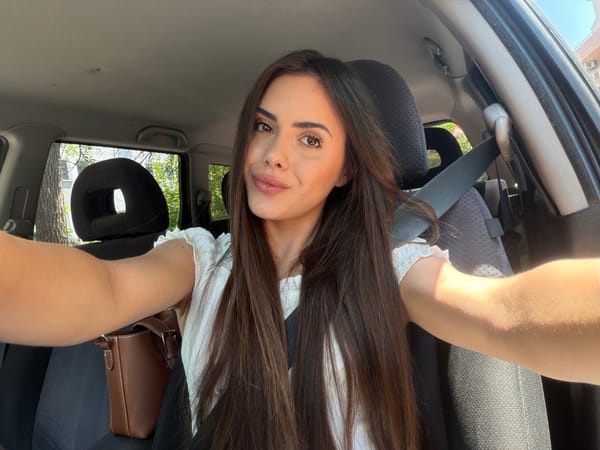 Woman takes selfies in car during morning in Burgas