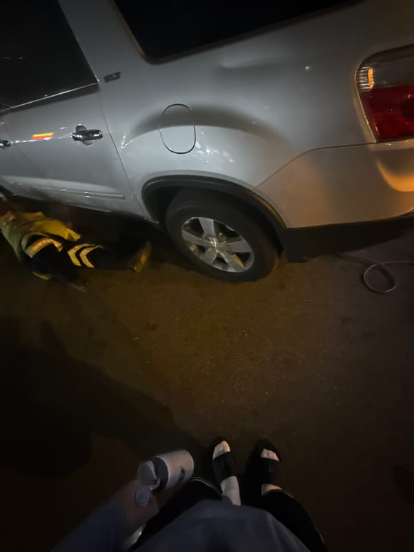 Light-colored SUV spotted on dark pavement in nighttime New York