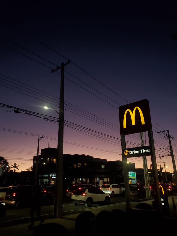 McDonald's Drive Thru sign glowing at dusk in Curitiba