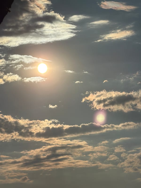Witness Reports Two Bright Light Sources Among Mixed Clouds