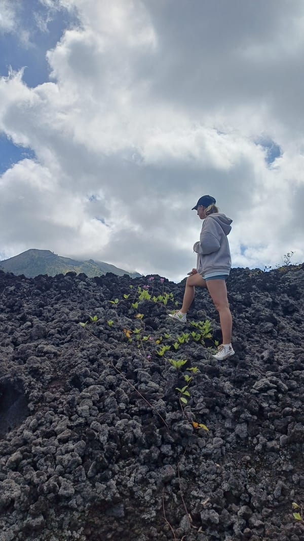 Tourist explores volcanic rocks in Kintamani early morning
