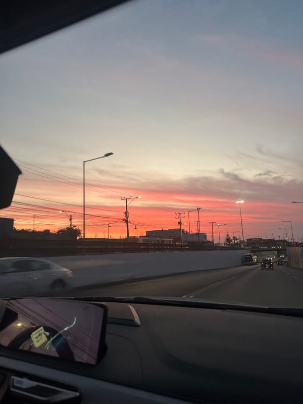 Vibrant sunset captured from moving vehicle in Arica, Chile