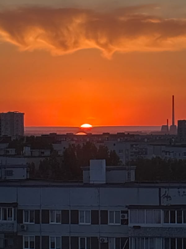 Urban sunset observed with orange skies behind city buildings