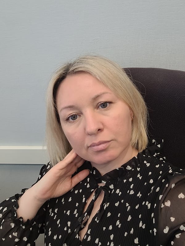 Woman poses indoors in heart-patterned blouse in Izhevsk