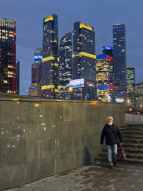 Man photographed on stairs with Moscow skyline backdrop